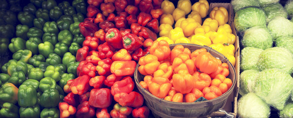 Variety of bell peppers on display for sale in market