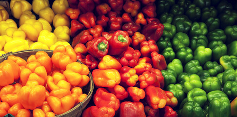 Naklejka na ściany i meble View of multicolored bell peppers on display in market