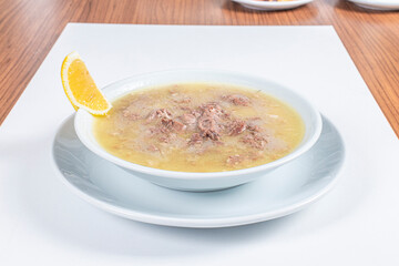 Turkish Traditional Soup with bread on white rustic wooden background, kelle, paca corbasi.