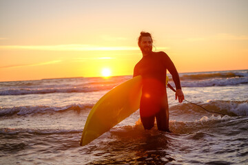 Male surfer with surfboard in sea