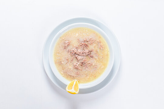 Turkish Traditional Soup with bread on white rustic wooden background, kelle, paca corbasi.