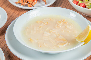 Turkish Traditional Soup with bread on white rustic wooden background, iskembe corbasi.