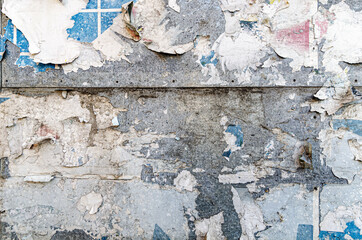 Poster wall texture, grungy background with peeled off dirty papers