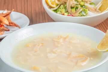 Turkish Traditional Soup with bread on white rustic wooden background, iskembe corbasi.