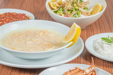 Turkish Traditional Soup with bread on white rustic wooden background, iskembe corbasi.