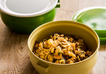 Fried chopped  chicken with noodles in food carrier , in door  Chiangmai  Thailand