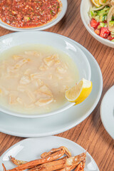 Turkish Traditional Soup with bread on white rustic wooden background, iskembe corbasi.