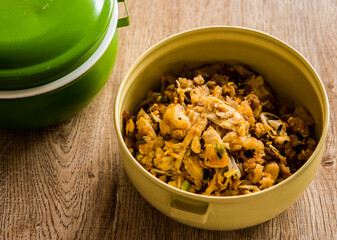 Fried chopped  chicken with noodles in food carrier , in door  Chiangmai  Thailand
