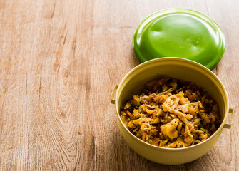 Fried chopped  chicken with noodles in food carrier , in door  Chiangmai  Thailand