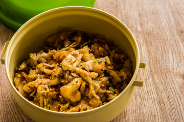 Fried chopped  chicken with noodles in food carrier , in door  Chiangmai  Thailand