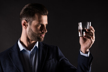 Close-up portrait of his he nice attractive content guy employer partner leader drinking old expensive luxury brandy cognac corporate occasion isolated on dark black color background