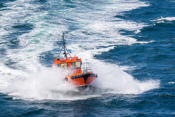 Pilot boat cutting through the waves