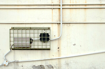 wall and electric pane with wire on the pipe