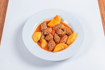 Turkish Traditional Soup with bread on white rustic wooden background, Izmir kofte yemegi.
