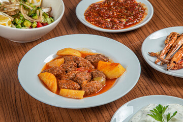 Turkish Traditional Soup with bread on white rustic wooden background, Izmir kofte yemegi.
