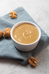 Walnut butter on the gray concrete background