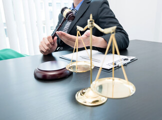 A professional male lawyer who works at a law firm has scales, Scales of justice, documents about justice, and lawsuits. Concepts of law and justice - obrazy, fototapety, plakaty