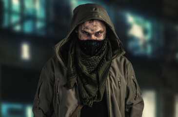 Dark photo of Young handsome man wearing black protactive face mask and hood