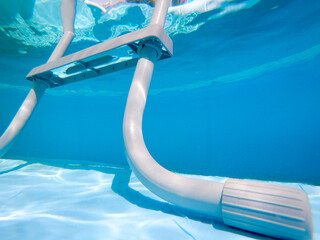 Underwater view of a grey pool ladder