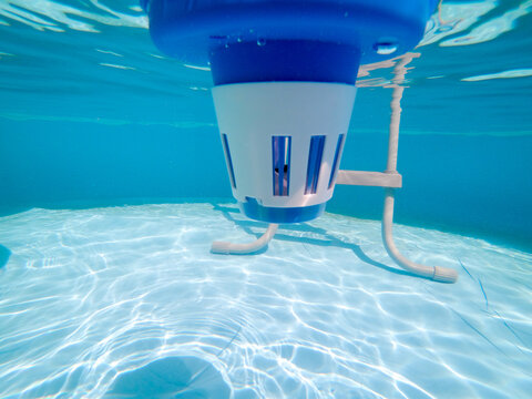 Underwater view of a chlorine dispenser in a swimming pool