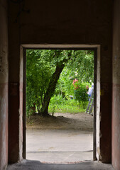 Exit from the narrow corridor that opens onto the courtyard of the apartment building