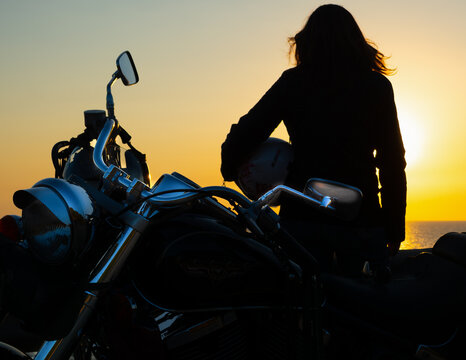 Close up of girl and motorcycle silhouettes
