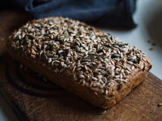 Rustic home made buckwheat seed loaf in low light on kitchen table
