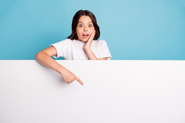 Fototapeta premium Portrait of nice attractive cheerful amazed wavy-haired girl demonstrating copy space ad advert advice isolated on bright vivid shine vibrant blue teal turquoise color background