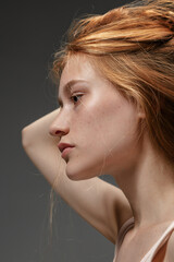 Deep emotions. Fashion portrait of beautiful redhead woman isolated on grey studio background....