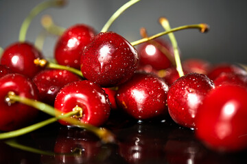 juicy red cherries on a black stone table
