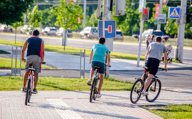 Cyclists ride on the bike path in the city Park
