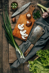 Green onions on an old wooden background. The view from the top. Art.