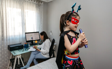 Girl singing in disguise while her mother teleworking