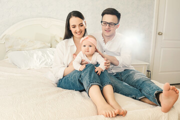 Happy young father, mother and cute baby