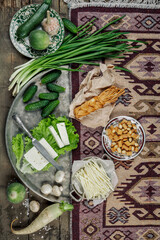 Still life with homemade milk cheese vegetables and herbs. The view from the top.
