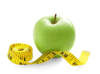 Yellow measure tape and green apple