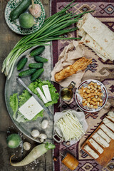 Still life with homemade milk cheese vegetables and herbs. The view from the top.