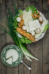 Still life with homemade milk cheese vegetables and herbs. The view from the top.