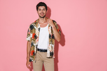 Portrait of cheerful young man smiling and posing on camera