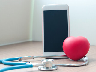 Doctor online concept, red heart with stethoscope and  smartphone for online consultation with patient, online medical communication on virtual interface, virtual hospital