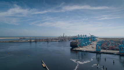 Fototapeta premium Huge cranes and ships anchored at harbor. International commercial port