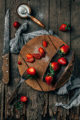 Ripe strawberries on an old wooden vintage background.