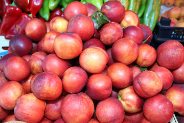 Peaches and nectarines on a market. Fruits pattern.