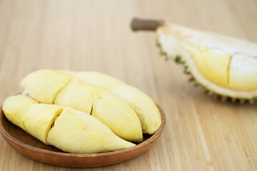 Fresh durian in wooden plate on table background, that has been referred to as the king of fruit. 
