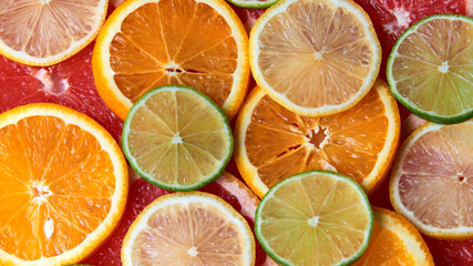 Fototapeta na wymiar Beautiful fresh sliced mixed citrus fruits like background. Concept of healthy eating, detox, diet. Top view.