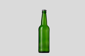 Empty green colored beer bottle. One object isolated on white studio background. Concept of beer, beverage, entertainment and alcohol. Copyspace for your bar, restaurant, brewery or shop advertising.