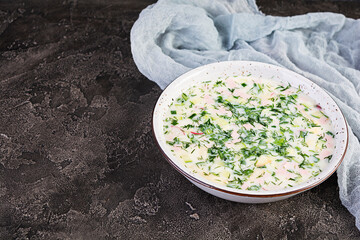 Russian traditional cold soup okroshka. Summer cold soup with yogurt and vegetables.