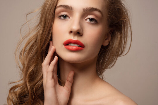 Young woman with perfect skin. Studio portrait. Closeup. Red lips. Girl with beautiful hair.