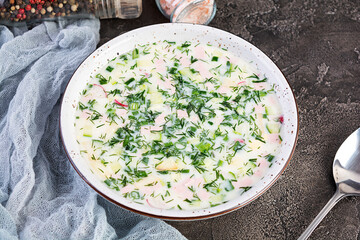 Russian traditional cold soup okroshka. Summer cold soup with yogurt and vegetables.