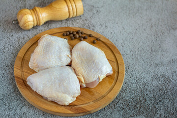 Raw chicken thighs on a chopping Board.Cooking.